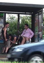 A girl with very big boobs has some public sex with two big dicks at the bus stop by a very busy highway